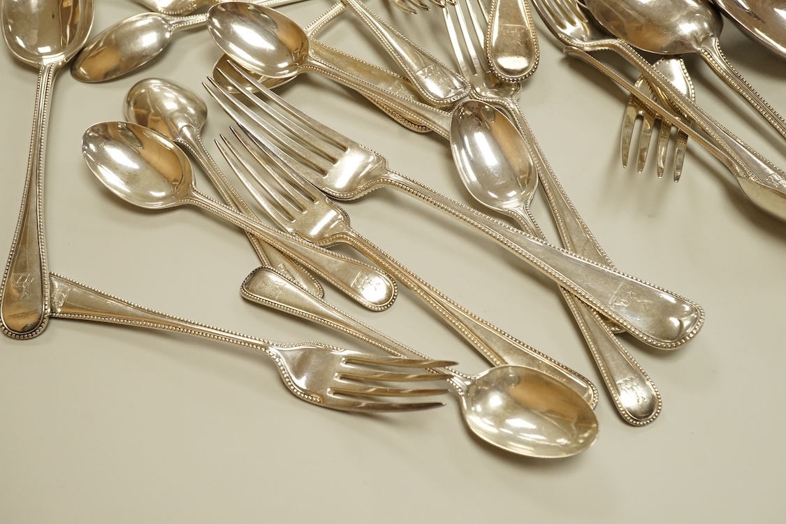 A harlequin part canteen of late Victorian and Edwardian silver beaded Old English pattern flatware, various dates and makers, comprising thirty items, 55.8oz.